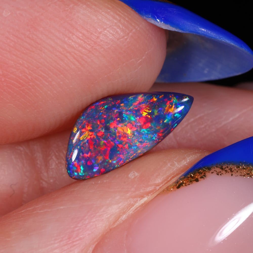 0.89 carat black opal showing bright red and pink fire galaxy pattern